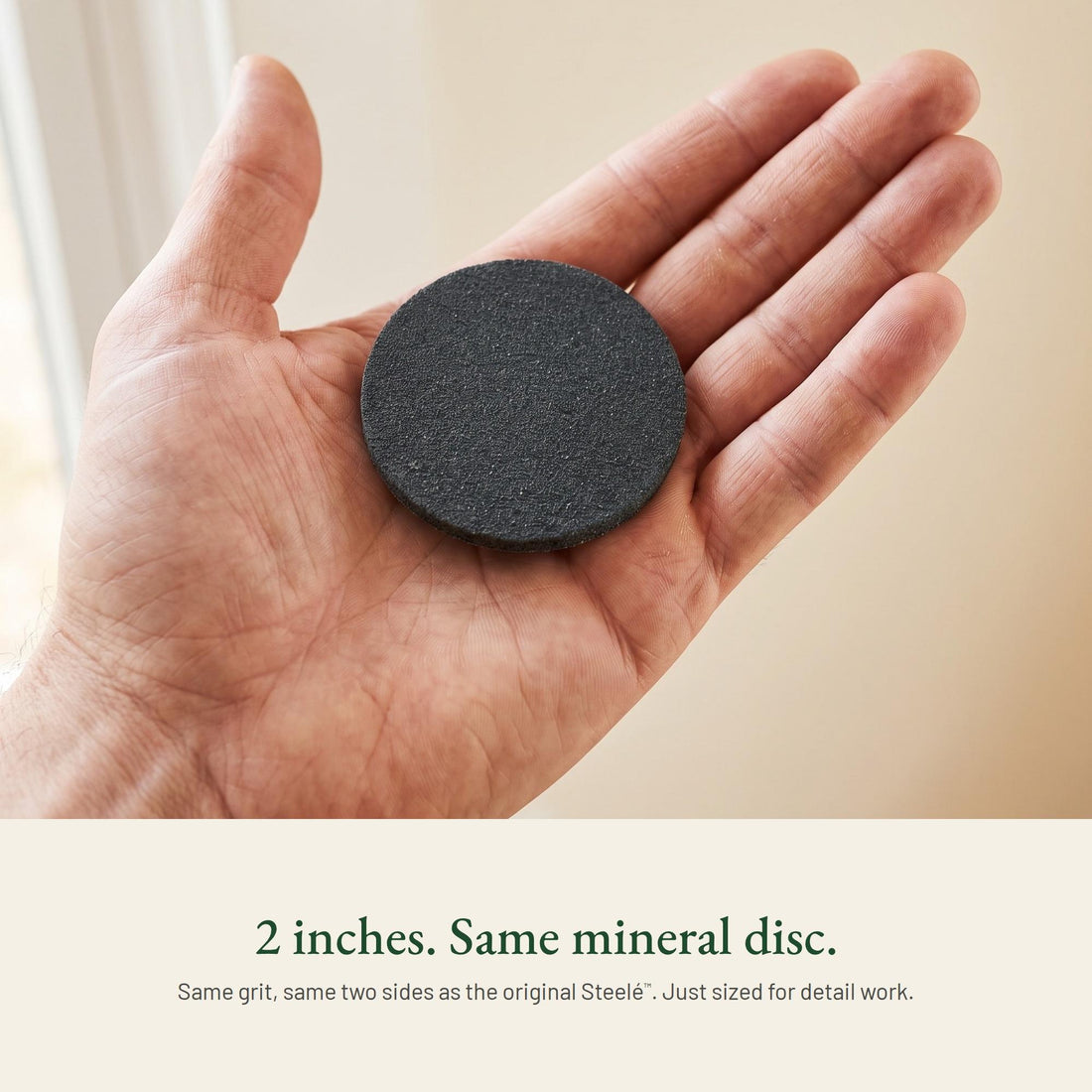 A Steelé Mini disc resting in an open palm